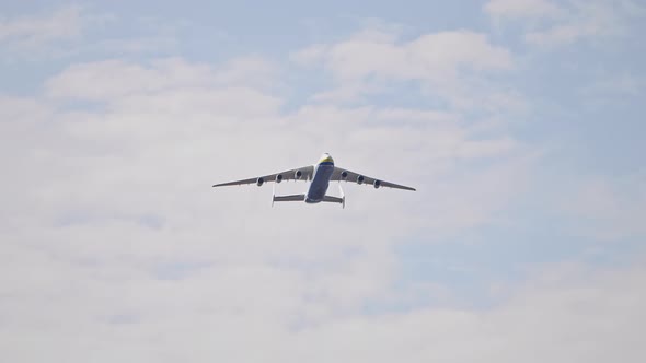 The Biggest Plane on Earth Flying in the Sky on a Low Altitude with Blue Skies on the Background