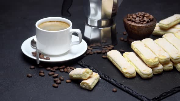 Italian Savoiardi Ladyfingers Biscuits and Cup of Coffee on Concrete Background