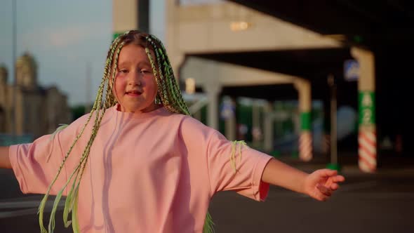 Professional child dancer expressing emotions using body close up. Girl dancing at parking