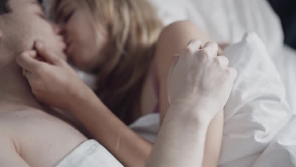 Close Up Portrait of Sensual Couple Embracing in Bed in Slow Motion