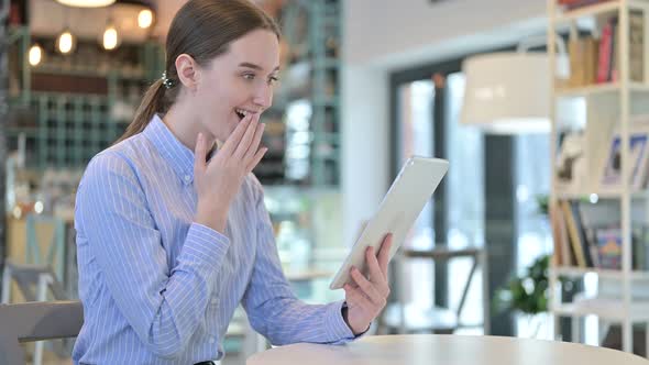 Young Businesswoman Celebrating on Tablet in Caf�, Success 