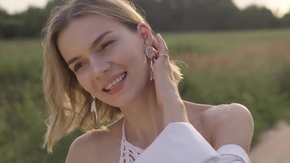 Young Woman at Sunset with Flower in Mouth