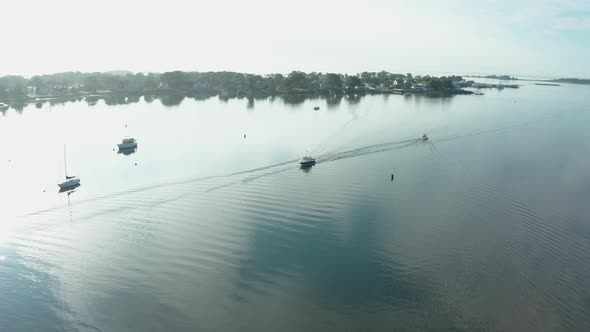 Aerial Drone Shot Tracking a Boat in a Quiet Harbor (Norwalk, Connecticut)