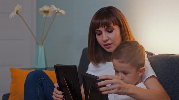 Happy Family  Woman Her Little Son Sitting Couch Looking Photographs Then Looking Camera