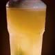 Pouring light beer into a rotating glass. - VideoHive Item for Sale