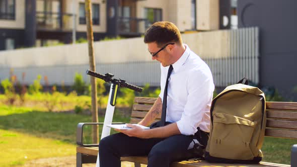 Businessman Writing To Notepad and Drinking Coffee