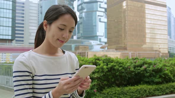 Woman use of cellphone at central of Hong Kong