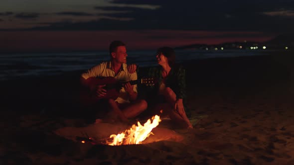 Smiling couple on beach after sunset