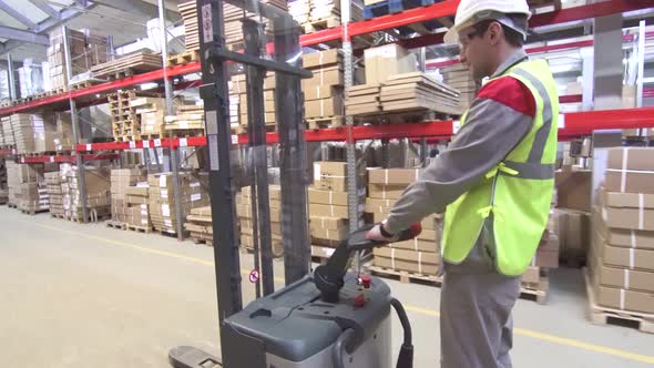 Warehouse Worker on Forklift Transporting Cargo