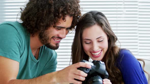 Photographer showing photos to fashion model