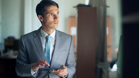 Young Businessman with Tablet in the Office