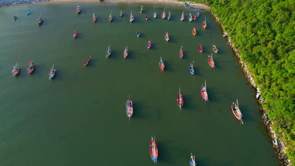 Many fishing boats on the coast beside the mountains, beautiful sea area in Thailand.