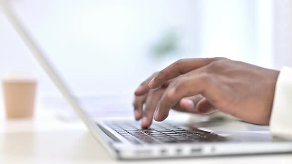 Close Up of Hands of Professional African Man Working on Laptop