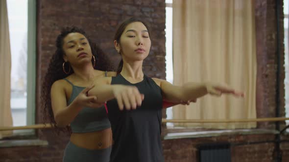 Asian Woman Training with Fitness Instructor at Gym