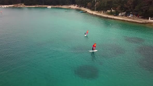 Aerial view of man practicing kitesurfing at transparent water, Croatia.