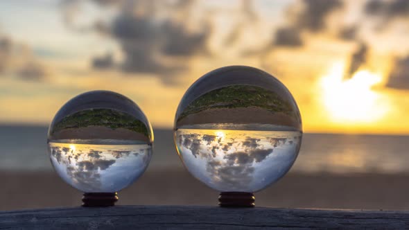 Time Lapse Two Crystal Balls On The Timber In Sunset.