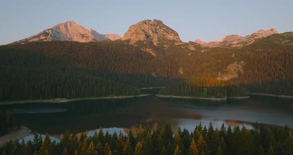 aerial view on durmitor mountain range and black lake with reflection