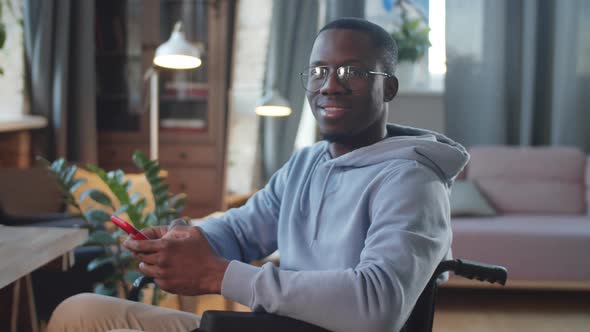 Portrait of Cheerful Black Man on Wheelchair at Home