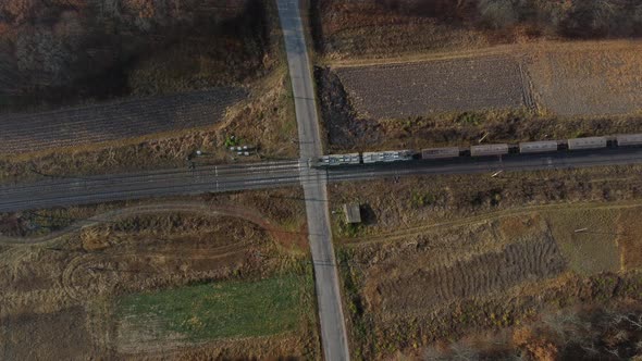 Top View Freight Train Passing Railway Crossing