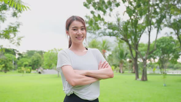 Portrait of Asian active sport woman stand with confidence after exercise outdoors at public park.