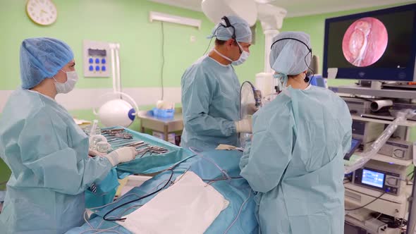 Doctors Are Watching a Tumor Inside a Head of Patient Using Endoscopic Camera in Surgery Room