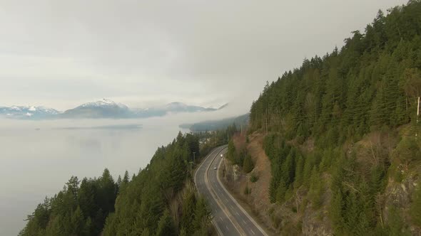 Aerial panoramic view of Sea to Sky Highway near Horseshoe Bay during a sunny winter evening before