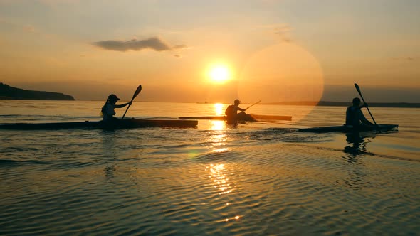 Sunset Waterscape with People Rowing