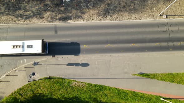 Top down bus - transport public road alone on empty street in Bydgoszcz - drone shot top down