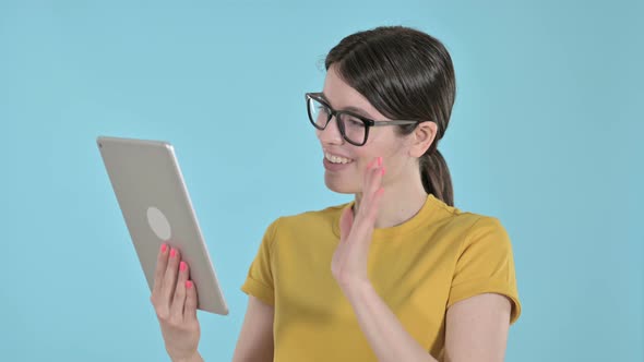 Young Woman Video Calling on Tablet on Purple Background 