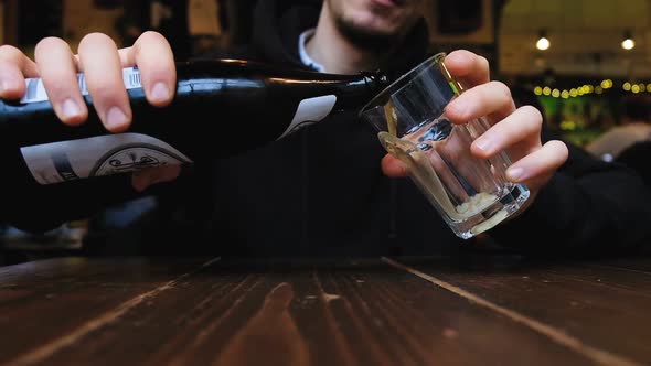 Man Pours Beer Into a Glass