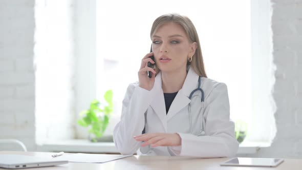 Lady Doctor Talking on Phone in Clinic