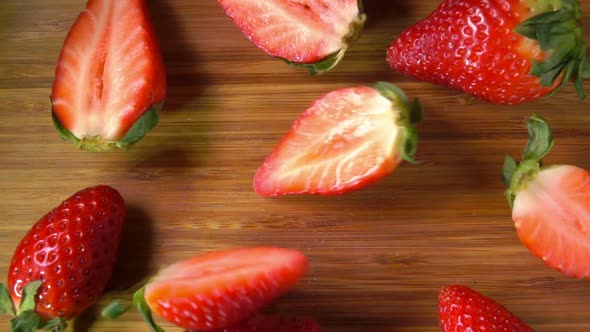 Juicy Red Strawberries Falls on the Wooden Surface