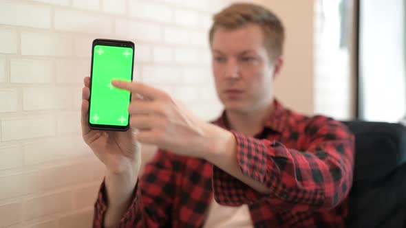 Young Happy Hipster Man Showing And Using Phone