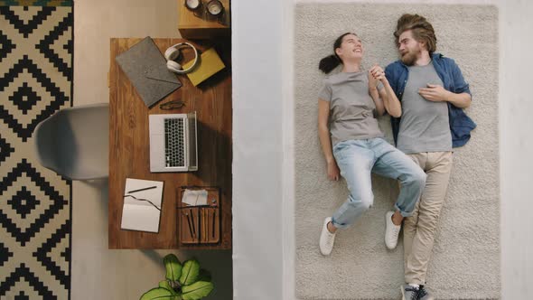 Top View of Couple Lying on Floor in Room