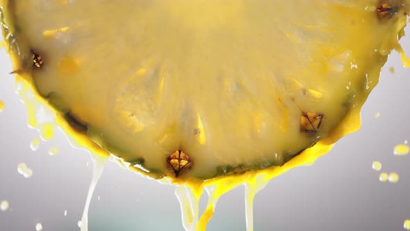 Flowing Pineapple Juice From Pineapple Slice Macro Shot in Slow Motion