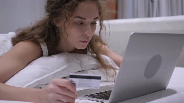 Successful Online Shopping By Female in Bed Paying By Credit Card