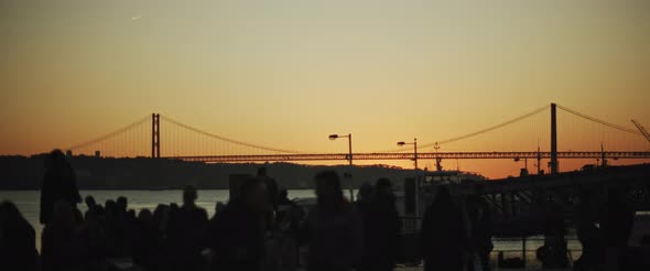 Silhouette of people watching sunset in the city port.