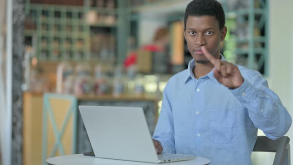 Serious African Businessman with Laptop Saying No with Finger 