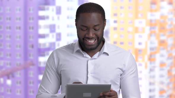 Afro-American Guy in White Shirt Using Pc Tablet.