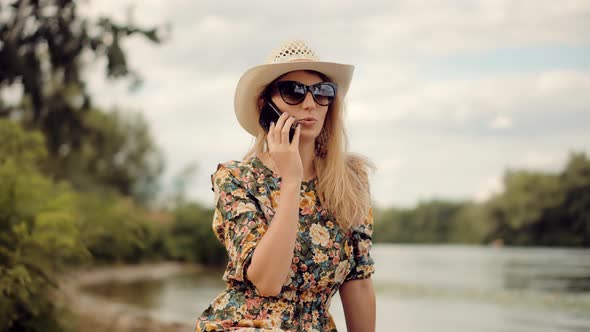 Businesswoman Talking On Phone Outdoor On Nature. Handsome Attractive Girl Talking On Cellphone.