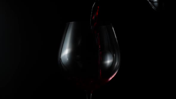 Slow Motion Pour Red Wine On Black Background