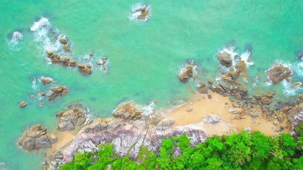 An aerial view from a drone flying over beautiful beaches and rocks