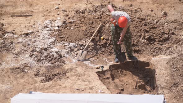 Young Archeologist Works on an Archaeological Site at Morning Sun Rays at Summer Heat