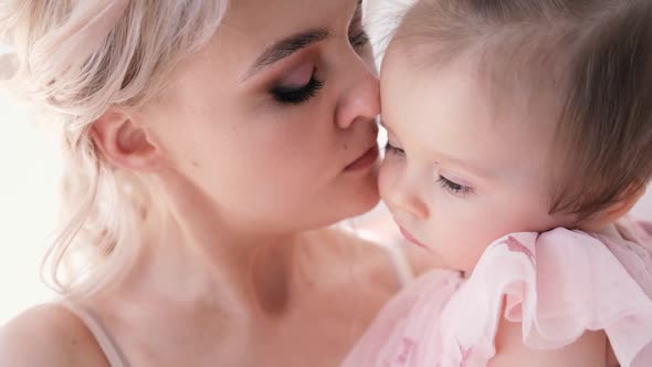 Little Girl Hugging with Mom