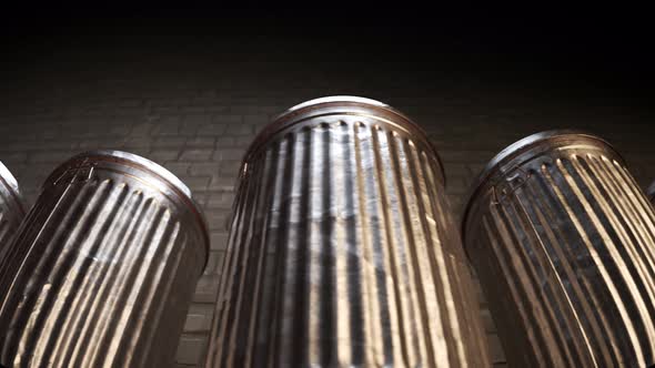 Steel trash bins stacked together in an endless loop lit by dim light. 4K HD