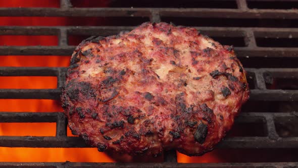Appetizing Burger Cutlet is Roasting on the Grill Grid Above Fire Flames