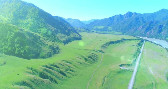 Aerial Rural Mountain Road and Meadow at Sunny Summer Morning