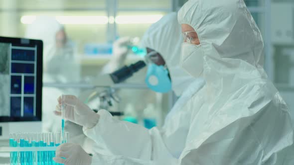 Scientist in Protective Coverall Suit Working on Vaccine in Lab