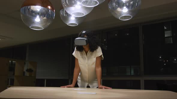 Businesswoman using VR helmet in a modern office