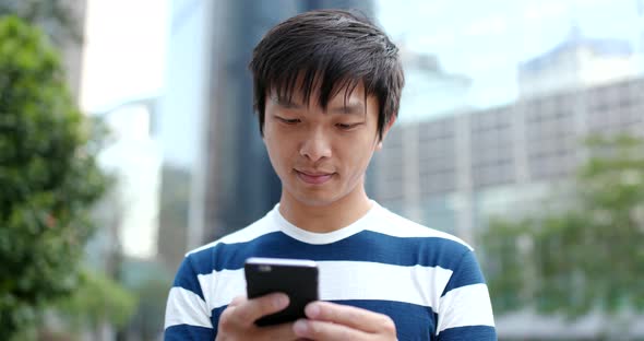 Young man use of mobile phone at outdoor
